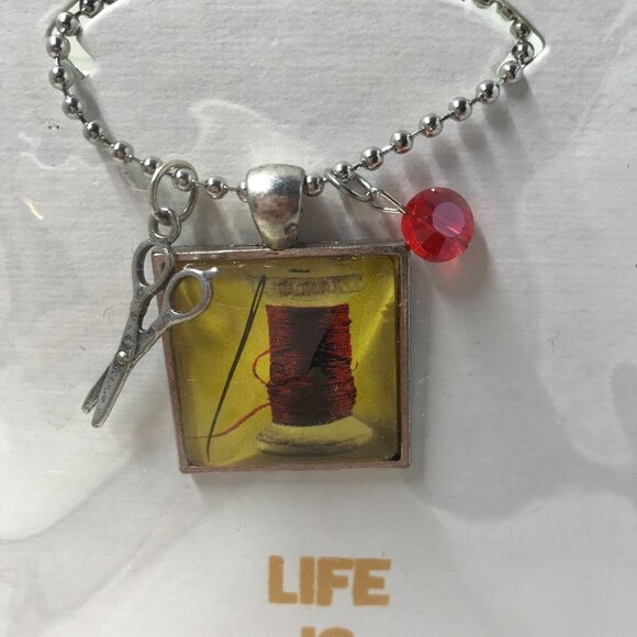 NEW Pendent necklace that has a needle and thread, 2 charms, & 22 inch chain - Picture 3 of 7